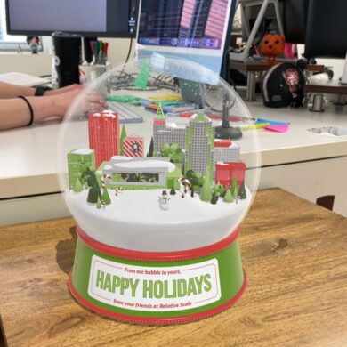 Happy holidays image from Relative Scale - a virtual snow globe on a desk